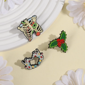 Detail of Christmas-themed enamel pins featuring skull holly and skeletal heart designs