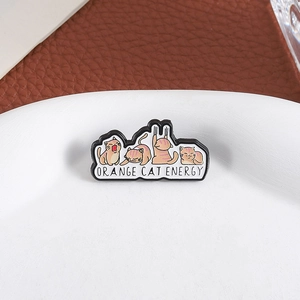 Detail of Orange Cat Energy enamel pin featuring four cute cartoon cats on a round plate