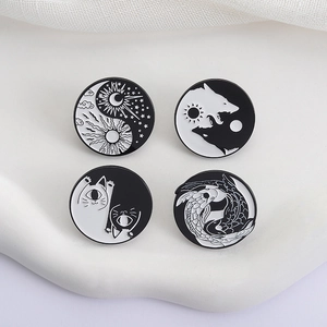 Set of four yin yang enamel pins featuring sun moon, wolf, cat, and koi fish designs