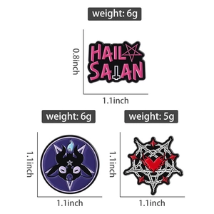 Detail view of occult enamel pins featuring pink Hail Satan text and baphomet goat designs