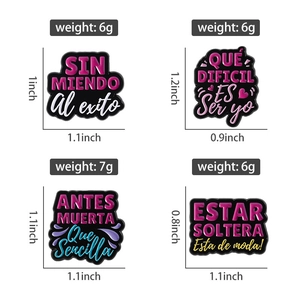 Detail view of four colorful Spanish inspirational enamel pins with weight and size specs