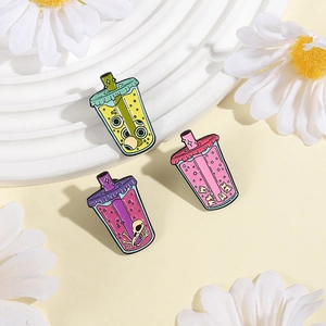 Detailed view of three quirky enamel pins featuring eye, teeth, and skull boba tea cups