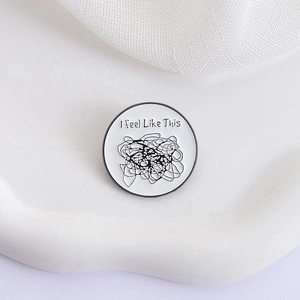 Minimalist circular enamel pin featuring 'I feel Like This' text and black doodle lines