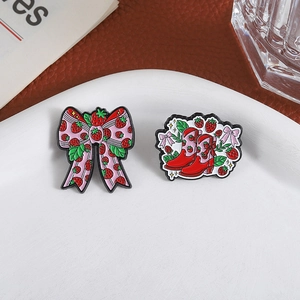 Cute strawberry bow and boot enamel brooch set in a stylish decorative plate display
