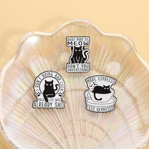 Funny black cat enamel pin set with witty quotes in a decorative shell tray