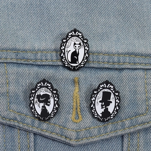 Gothic skull and cat enamel pin set on denim jacket featuring Victorian frame style