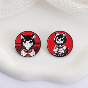 Set of two round enamel pins featuring cute cartoon cats in sailor school uniforms
