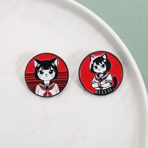 Set of two round enamel pins featuring cute cats in sailor uniforms on white ceramic
