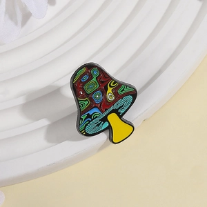 Artistic psychedelic mushroom enamel brooch with colorful patterns on a white pedestal