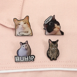 Detail shot of four funny cat enamel pins featuring viral meme internet expressions