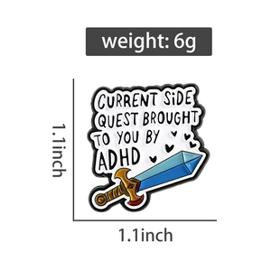 Detail showing ADHD sword enamel pin with current side quest text on white background