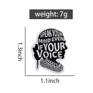 Detail view of monochrome enamel pin with profile silhouette and inspirational quote