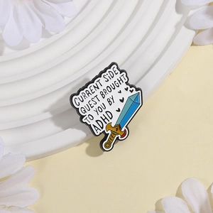 Detail of ADHD sword enamel pin on a white display stand with daisy flowers decor