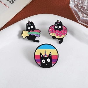 Three-piece black cat enamel pin set with rainbow shooting star and donut designs