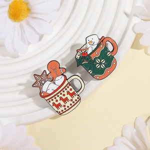Close-up of Christmas enamel pins featuring snowman and gingerbread man in mugs