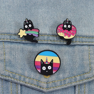 Cute black cat enamel pins set featuring rainbow stars and donuts on denim jacket
