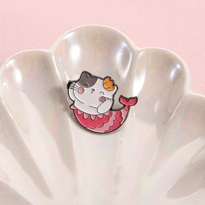 Cute cat mermaid enamel pin badge featuring a pink fish tail on shell display tray
