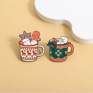 Festive Christmas mug enamel pins featuring gingerbread man and snowman designs