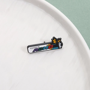 Detail view of Powered by ADHD enamel pin on a white plate with a yellow lightning design