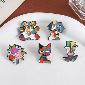Five-piece Picasso-style enamel pin set with abstract flower, animal, and face designs