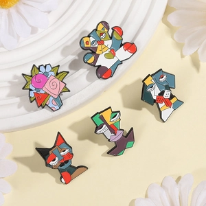 Detailed view of five Picasso style enamel pins on a decorative tray with daisies