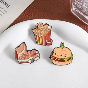 Three creative enamel pins featuring kitten-shaped burgers, fries and chicken nuggets
