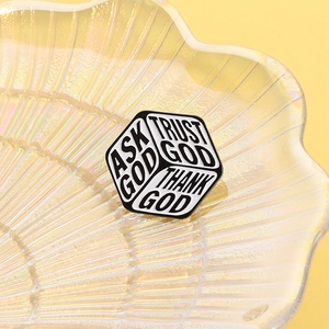 Detail of hexagonal enamel brooch with Trust God inspirational quotes in shell tray