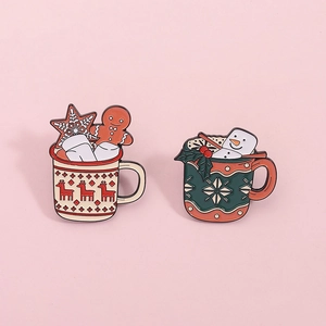 Christmas enamel pins set featuring festive gingerbread mug and snowman designs on pink back
