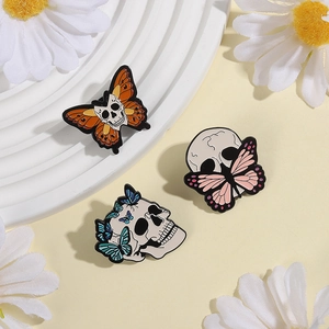 Detail of gothic dark style butterfly skull enamel pins with alloy dripping oil finish