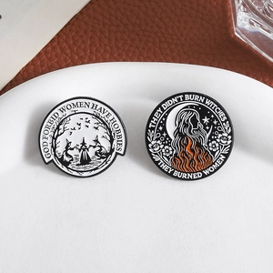 Retro witch enamel pin collection featuring feminist slogans on a white ceramic plate