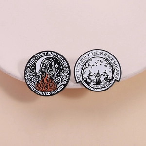 Retro feminist enamel pins featuring witch illustrations and meaningful text on ceramic tray