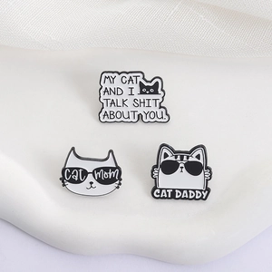 Enamel cat brooches set with Cat Mom, Cat Daddy and funny quote badges on white textile