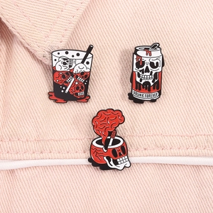 Detailed view of punk enamel pins featuring skull bubble tea and soda cans on denim jacket