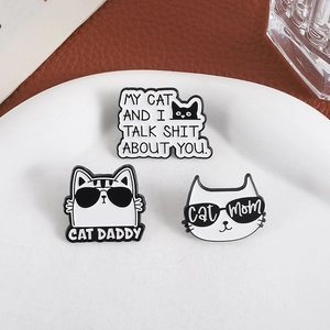 Three-piece black and white enamel cat pins featuring Cat Daddy and Cat Mom designs