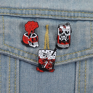 Three punk Halloween skull pins on denim jacket featuring brain and drink motifs