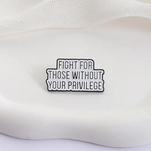 Enamel brooch with 'Fight for those without your privilege' text on ceramic plate