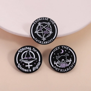 Three circular feminist witch enamel pins featuring stars and hats on a peach background