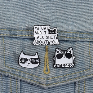 Three cat enamel pins on denim jacket with Cat Mom and Cat Daddy humorous funny text