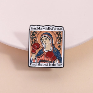 Enamel lapel pin with boxing Virgin Mary design on a pastel pink background