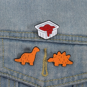 Creative dinosaur chicken nugget enamel pin set with dipping sauce on denim jacket