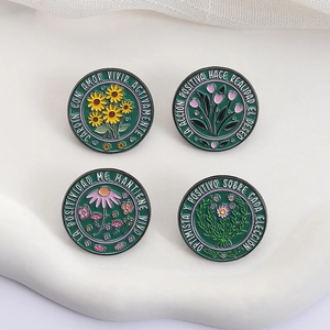 Set of four green flower enamel brooches with Spanish motivational quotes on a wavy base