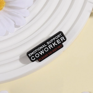 Enamel brooch pin with Emotional Support Coworker text and black metal finish