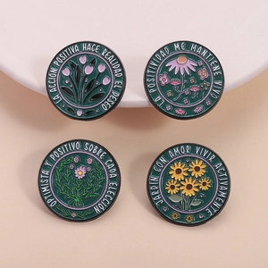 Set of four circular floral enamel pins featuring tulips and sunflowers on green background