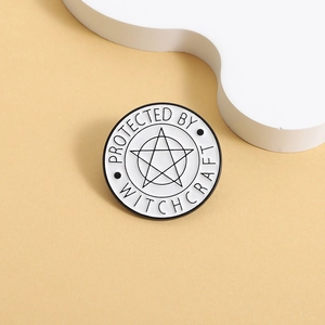 Minimalist black and white pentagram enamel pin badge with Protected by Witchcraft text
