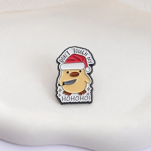 Detail of Christmas yellow duck enamel pin with 'DON'T TOUCH MY HOHOHO!' text