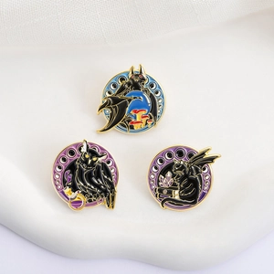 Close-up of enamel mystery pins featuring bats, owls and cats on textured white background