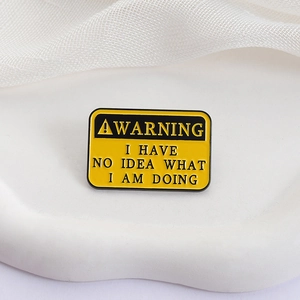 Warning sign enamel pin with I Have No Idea What I Am Doing text on white tray