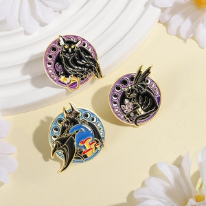 Gothic enamel pin set with black cat, owl and bat designs on white floral background