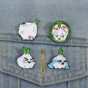 Funny garlic enamel pins on denim jacket featuring cute cartoon facial expressions