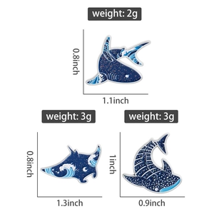 Detail view of ocean-themed shark and ray enamel pins showing sizes and weights